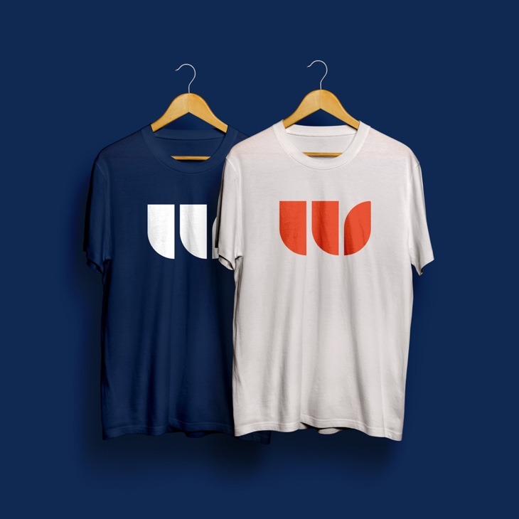 Two t-shirts showcasing the Walker Sands brand, logo badge and colors