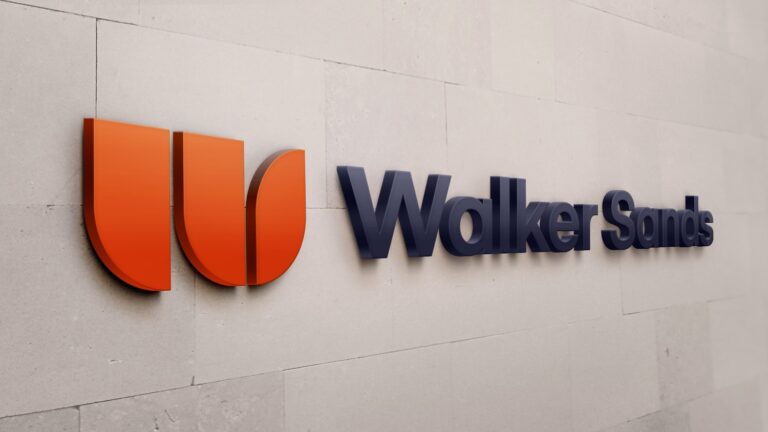 photo of the new Walker Sands logo and name against a white stone wall