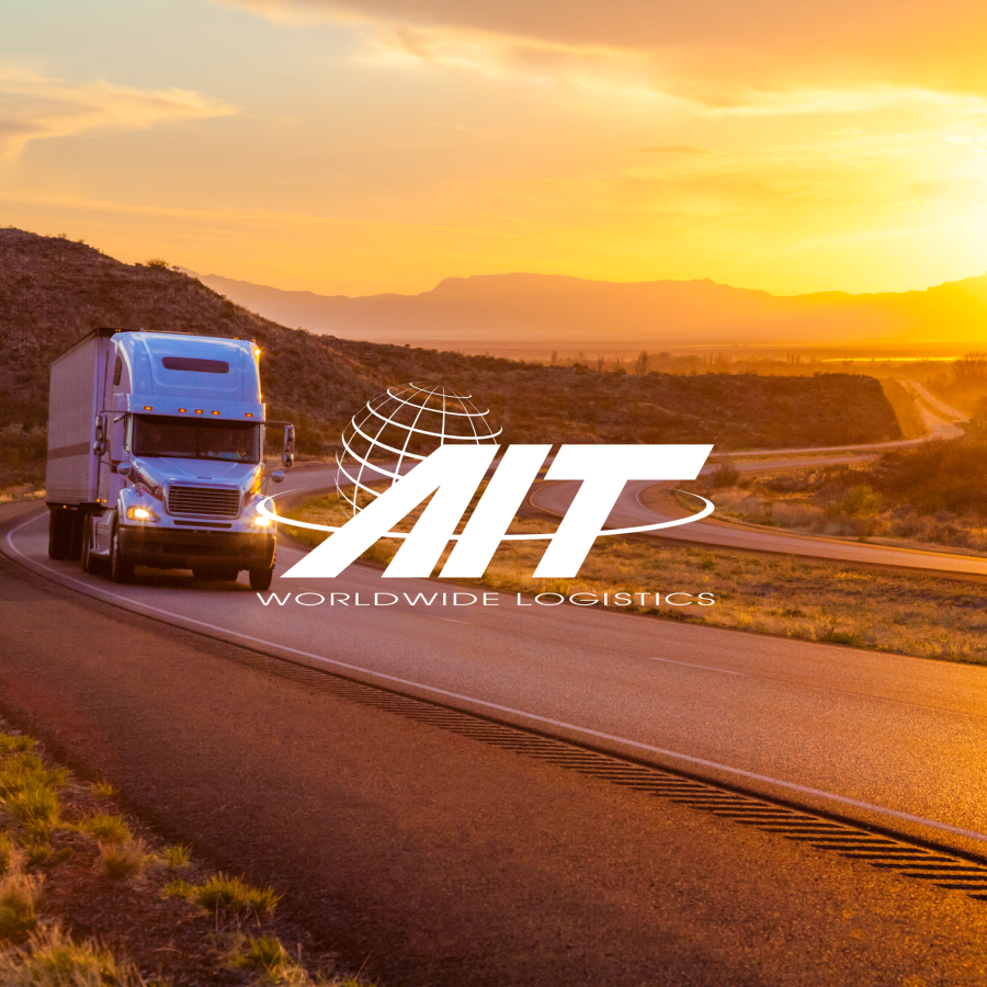 a tractor trailer on a open road at sunset with the AIT Worldwide Logistics logo on top of the image