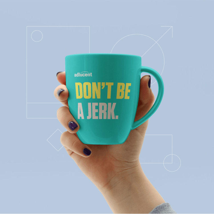 Mockup of Adlucent "Don't be a jerk" mug in new brand voice