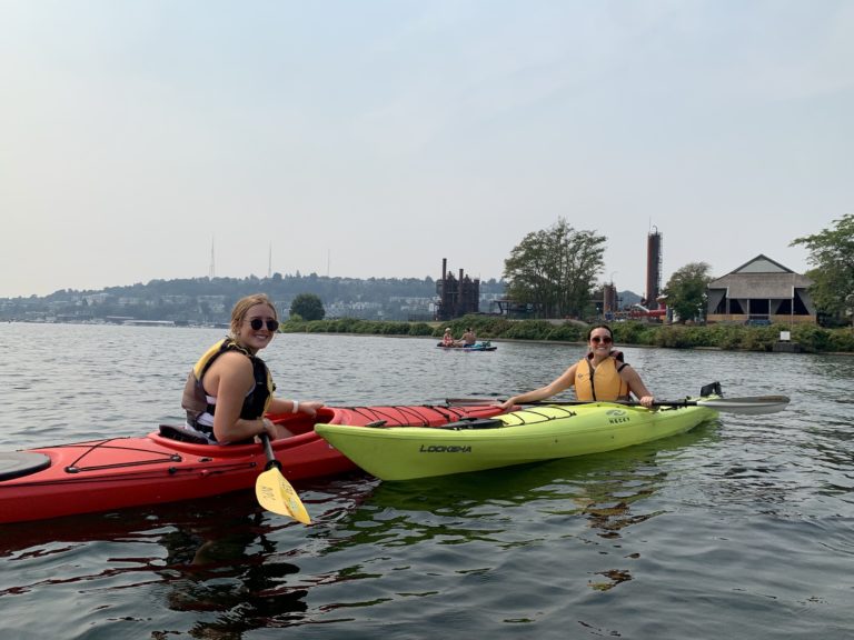 Two Walker Sands Seattle team members in kayaks during their annual outing