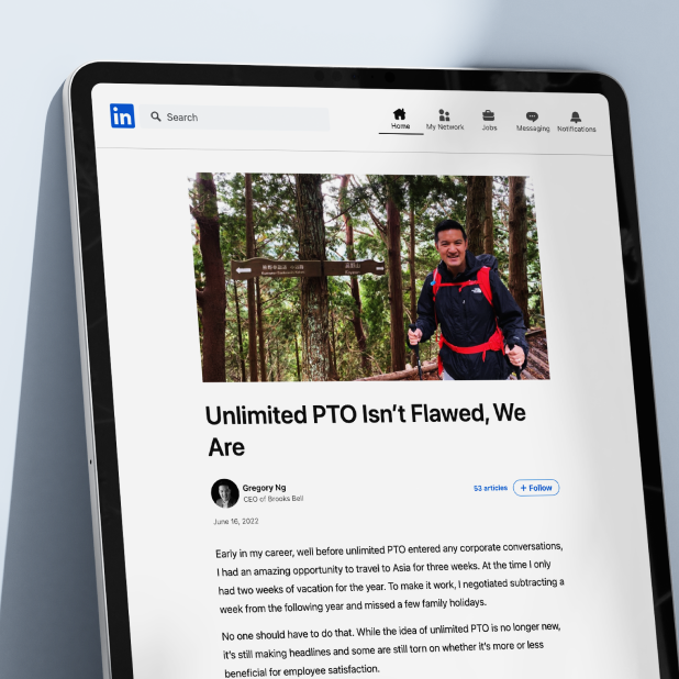 tablet displaying Gregory Ng LinkedIn article titled "Unlimited PTO isn't flawed, we are" with an image of him hiking