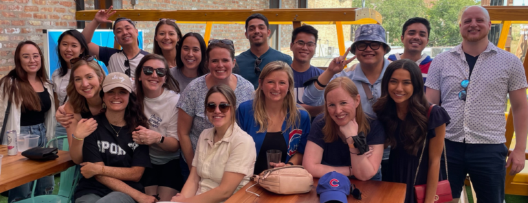 Walker Sands employees gathered as a group at a table outside