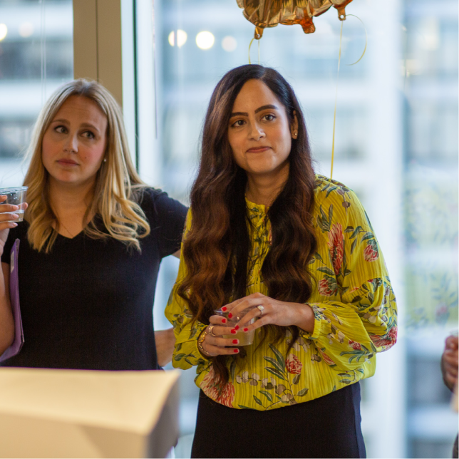 Two women listening to a sentimental speech