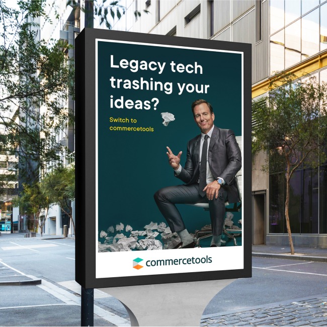 rendering of bus stop billboard from the naysayer campaign reading "legacy tech trashing your ideas?" that shows will arnett as the naysayer throwing crumpled pieces of paper  