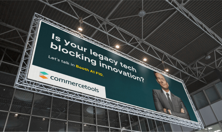 photo of a commercetools billboard at an event reading "is your legacy tech blocking innovation?" with will arnett posing as the naysayer