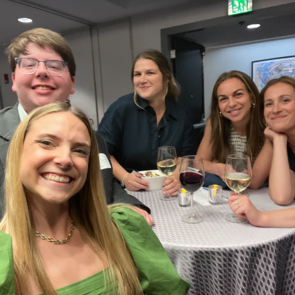 Group of five people taking a selfie at an award ceremony