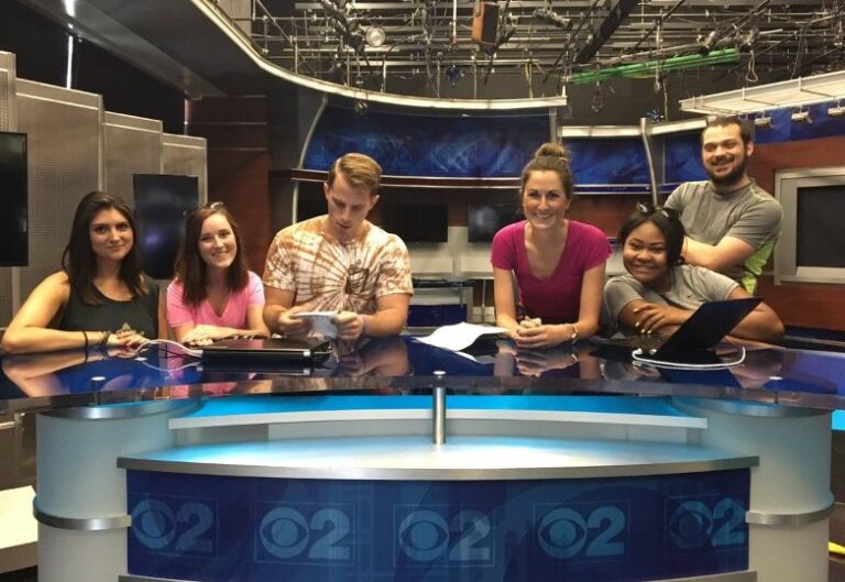 Six Walker Sands employees behind the CBS news desk