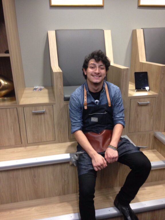 Jorge Lopez wearing blue denim shirt and apron