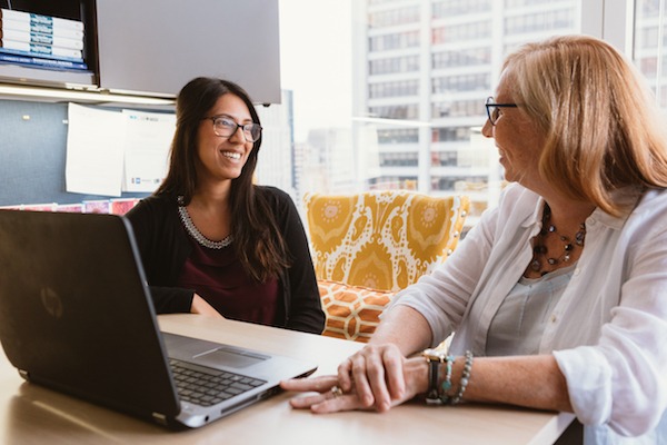 Two women sitting together in an office