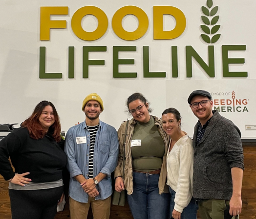 Five people standing in front of a wall that says "Food Lifeline."