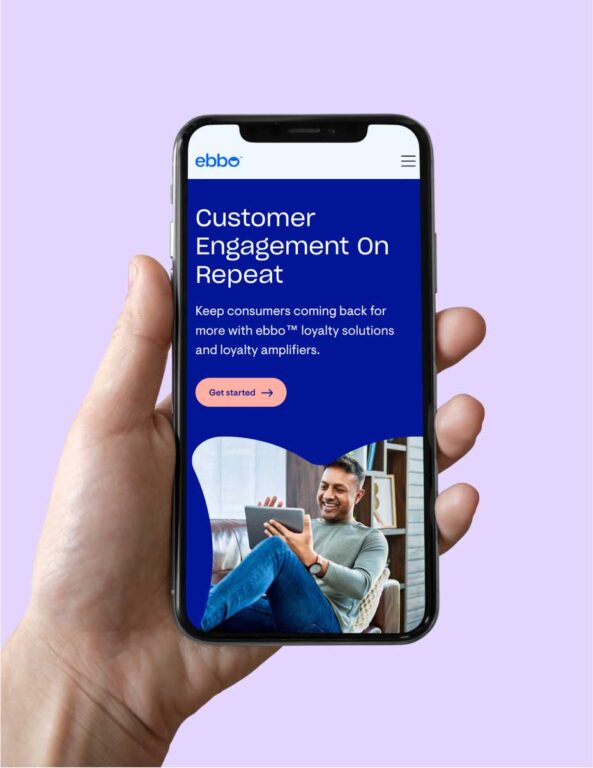 a hand holding a smartphone displaying a page from the echo website titled "customer engagement on repeat" on a dark blue background illustrated by a picture of a smiling man sitting on a couch looking at a tablet