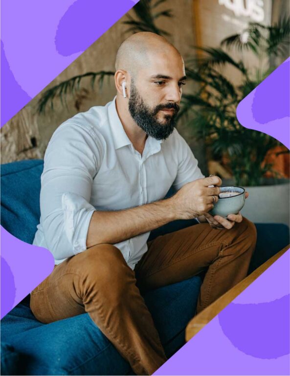 a photo cutout in an ebbo brand shape showing a man with earbuds in holding a ceramic bowl in front of a potted plant while sitting on a low blue couch