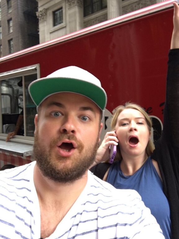 Selfie of two people in front of a red food truck