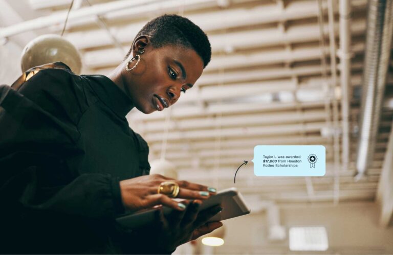 woman looking at a tablet with an arrow pointing to an animated speech bubble that reads "Taylor L. was awarded $17,000 from Houston Rodeo Scholarships"