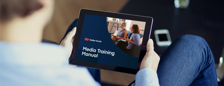 Man on ipad looking at media training manual