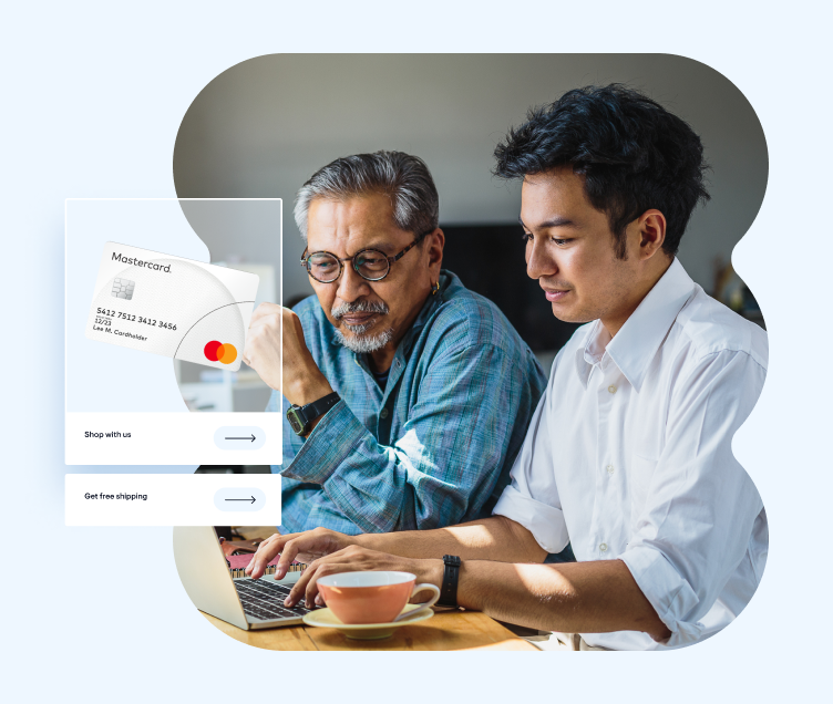 Two men sitting at a computer with a Mastercard photo insert