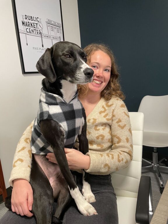 A Walker Sands Seattle team member with a dog in their lap