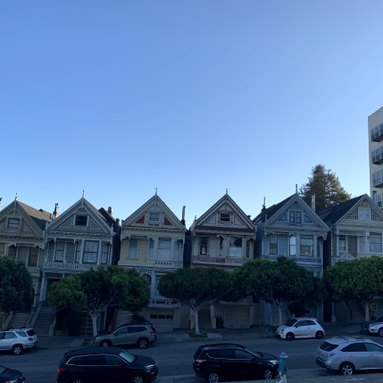 Six houses next to each other in front of a street