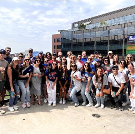 A group of people posing at Wrigley Field in Chicago. 