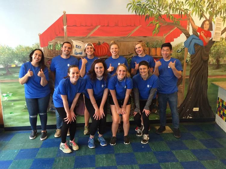 Group of eight Walker Sands employees wearing blue t-shirts