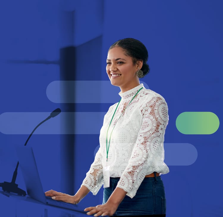 a smiling woman in a white lace shirt standing at a lectern