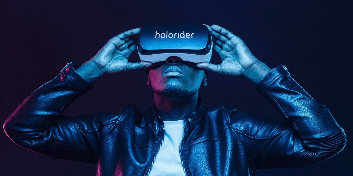 Person looking into AR device with text reading "holorider" over the device