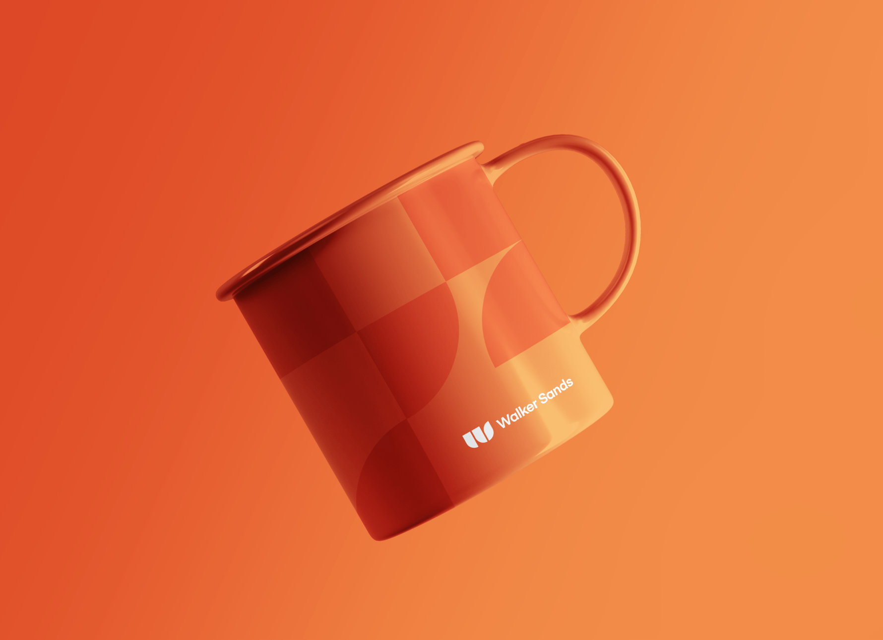 an orange mug with shapes from the new Walker Sands logo in darker orange