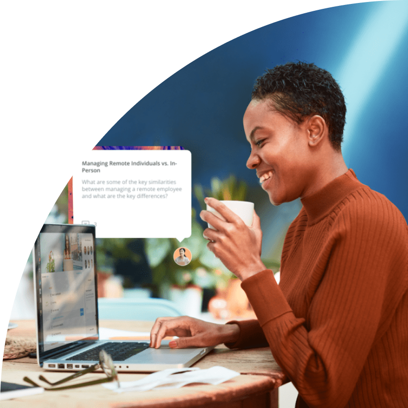 Woman working on computer sipping coffee