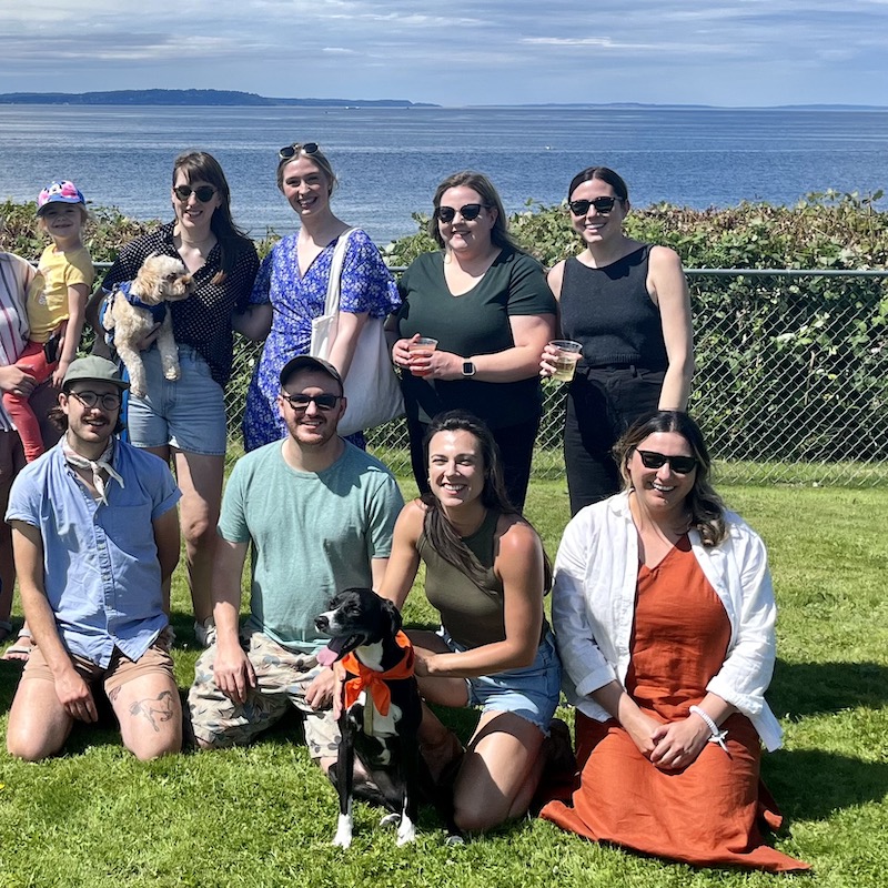 Group of Walker Sands Seattle employees posing for picture in front of ocean