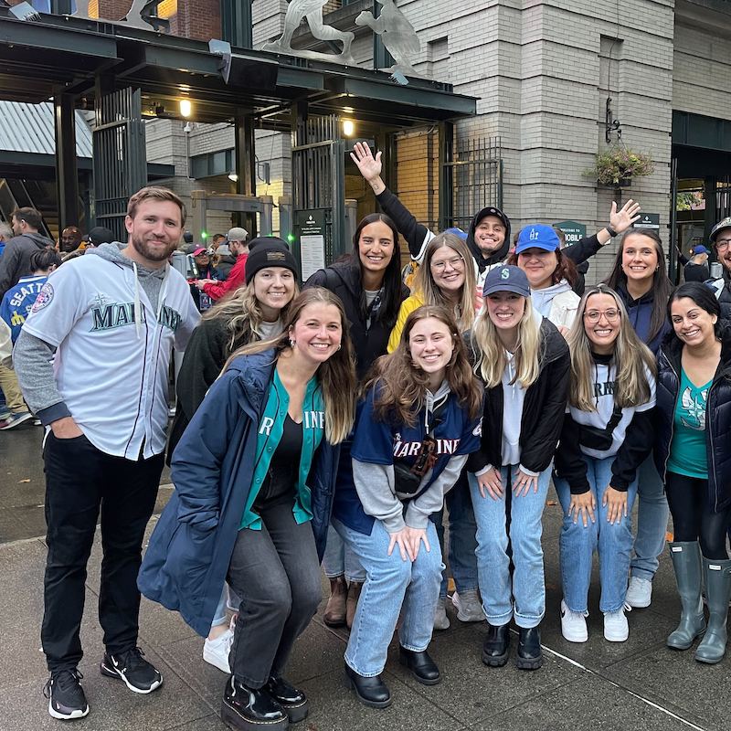 Group of Walker Sands employees poised outside the gates of the Seattle Mariners ballpark