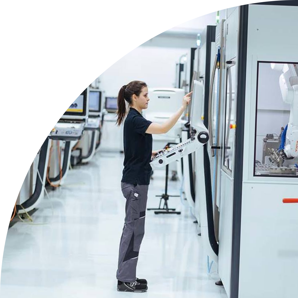 Woman with black shirt in factory pressing a button on a machine