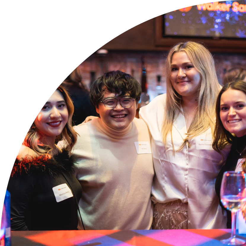 Holiday Party Photo with four smiling coworkers wearing name tags